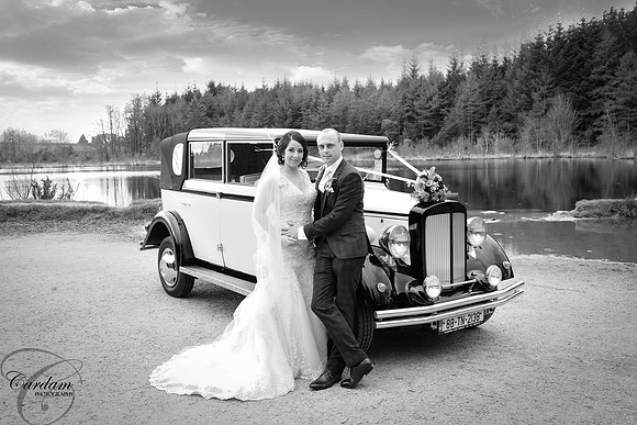 Bride and Groom with Vintage wedding car in Cratloe Woods, Co Clare